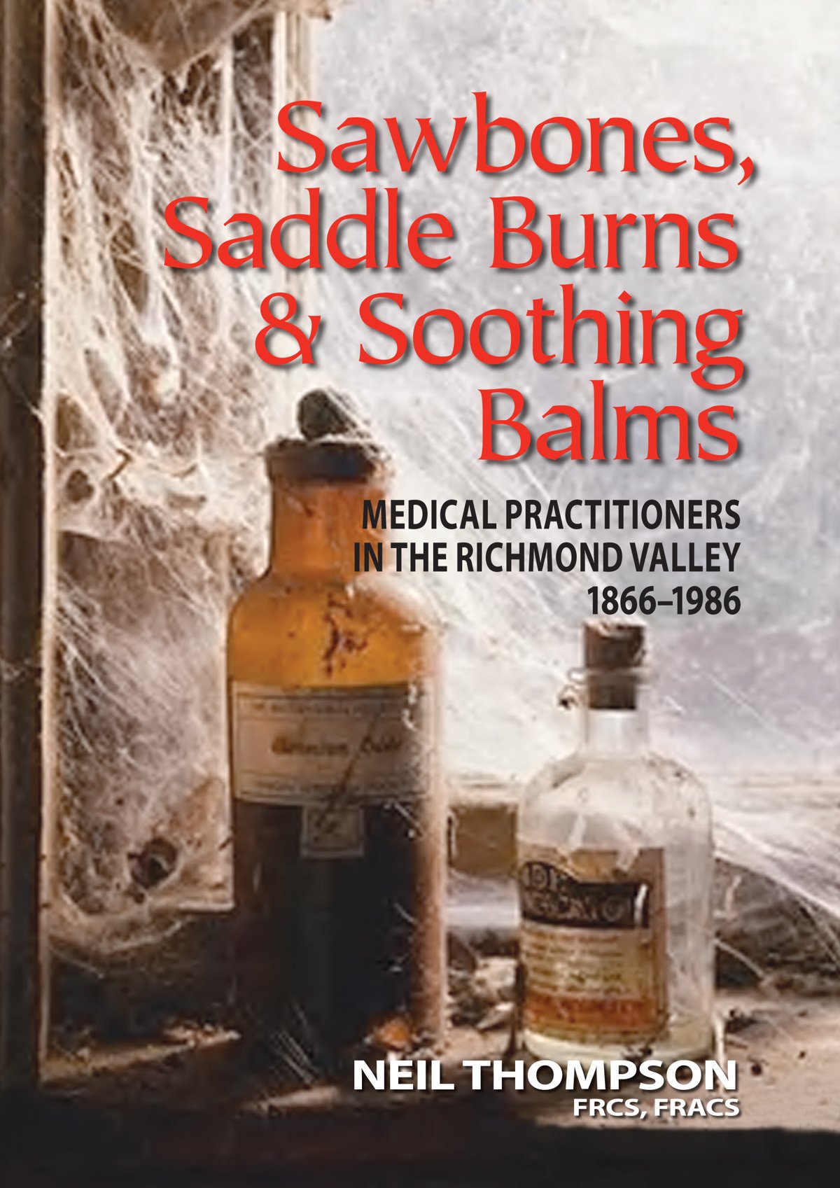 Cover of Sawbones, Saddle Burns and Soothing Balms: old medicine bottles in a cobwebbed window
